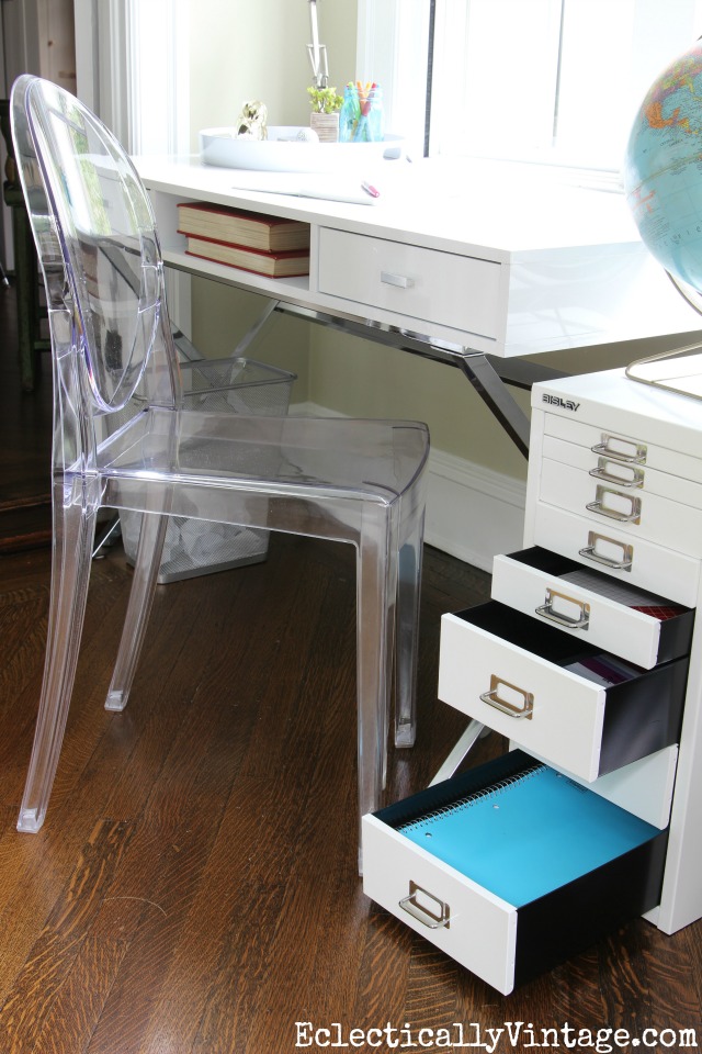 Love all the storage in this modern home office space and the clear ghost chair is beautiful kellyelko.com