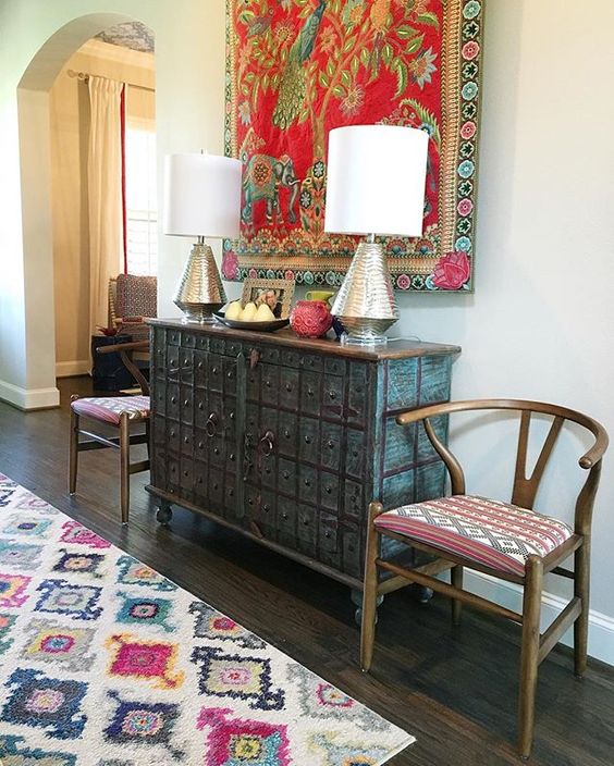 Eclectic mix of furniture in this colorful foyer - love the colorful tapestry kellyelko.com