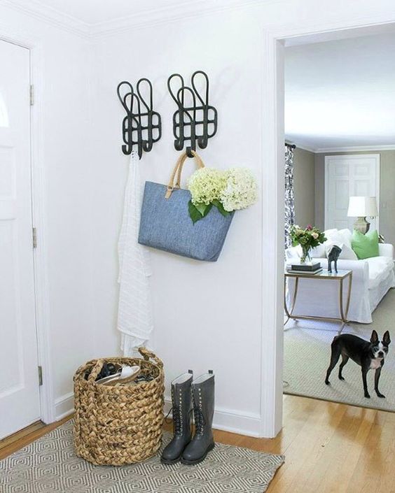 Love the oversized coat hooks in this white foyer kellyelko.com