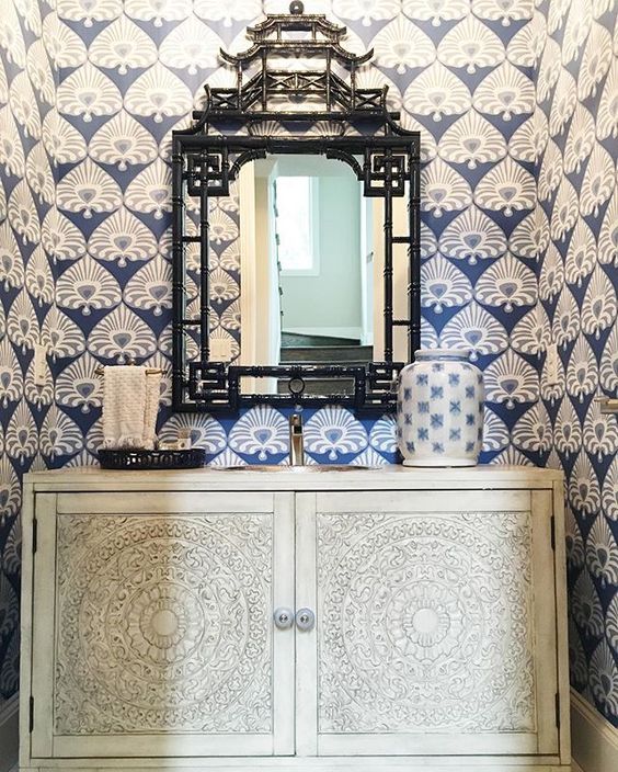 Love the blue and white wallpaper in this small powder room and the pagoda mirror kellyelko.com