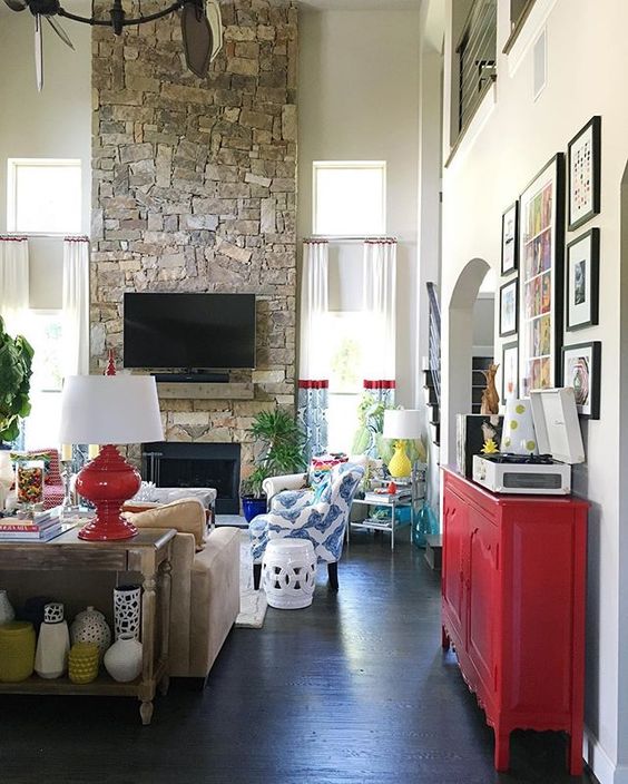 Love this huge stone fireplace in this colorful family room kellyelko.com