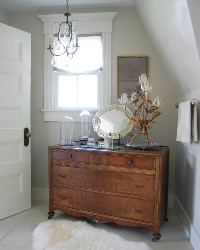 Antique wood chest in the bathroom adds warmth kellyelko.com