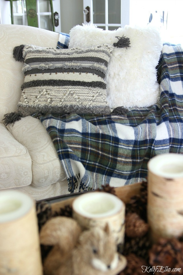 Love the gray boho tassel pillow with blue plaid throw - so cozy! kellyelko.com