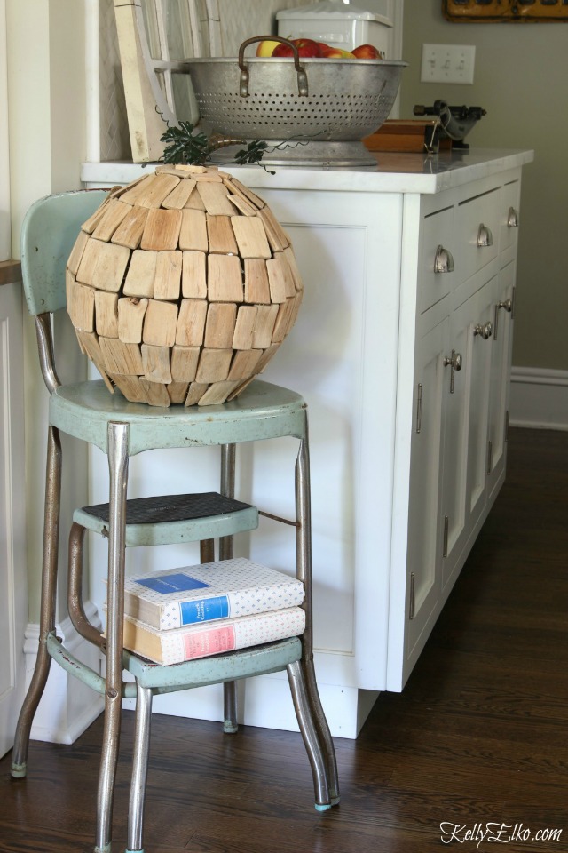 Love this driftwood pumpkin on a vintage step stool kellyelko.com