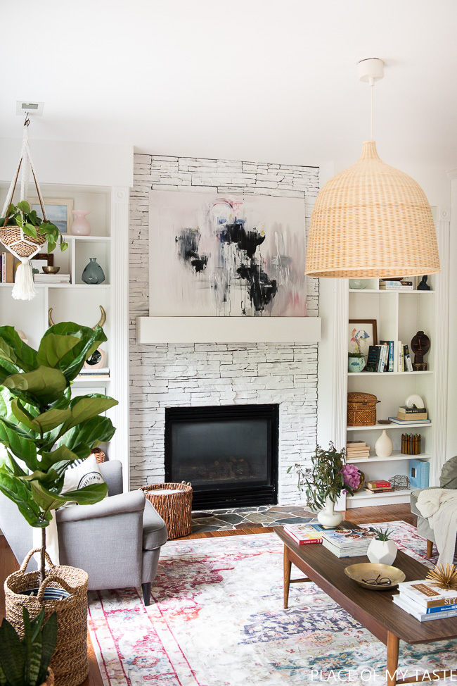 Bohemian living room - love the oversized pendant light and stone fireplace kellyelko.com