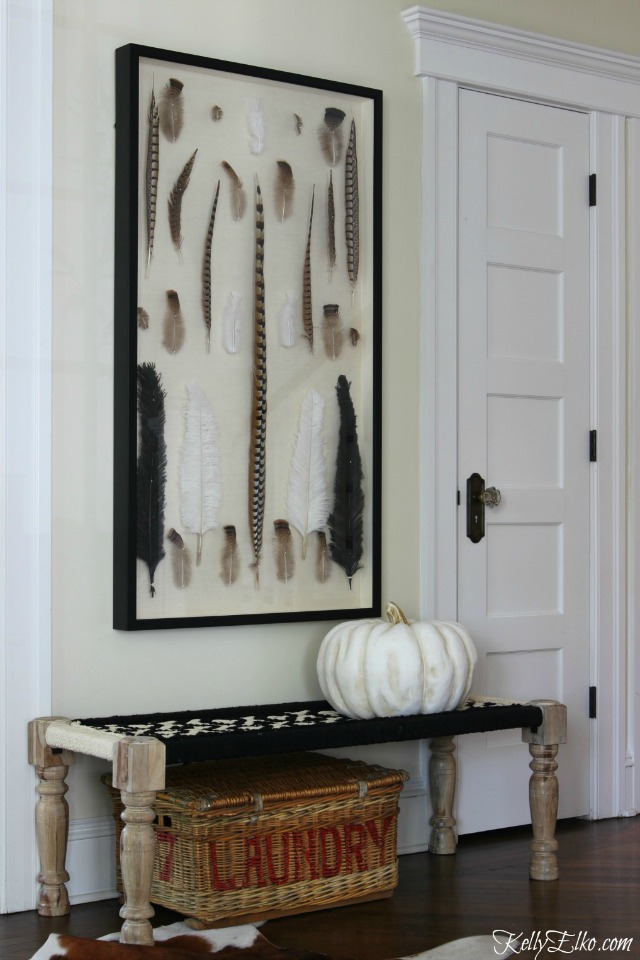 Love the giant feather shadowbox and black and white woven bench kellyelko.com