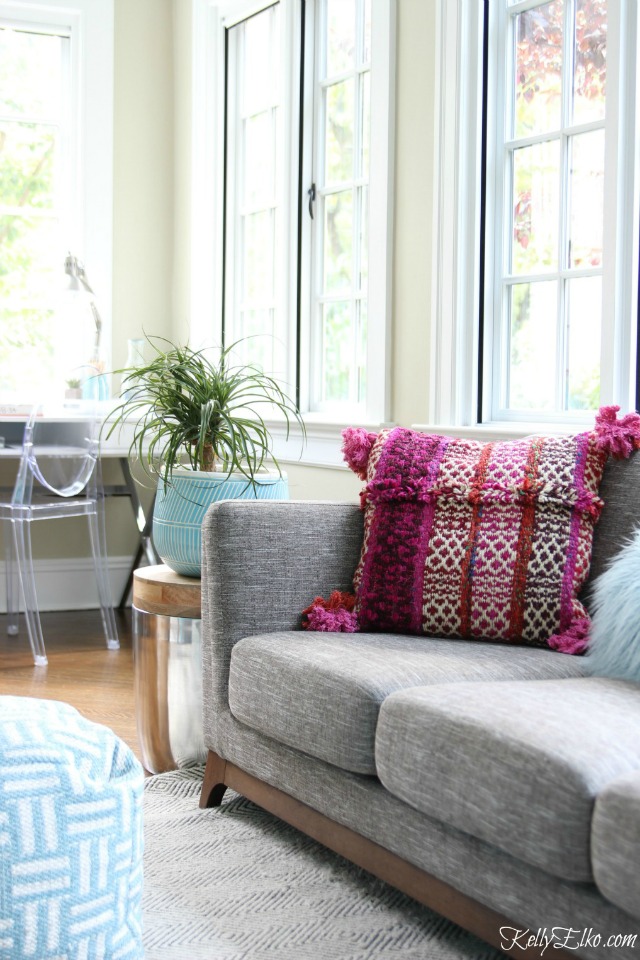 Love this sunroom and gray sofa with fun pink pillow kellyelko.com