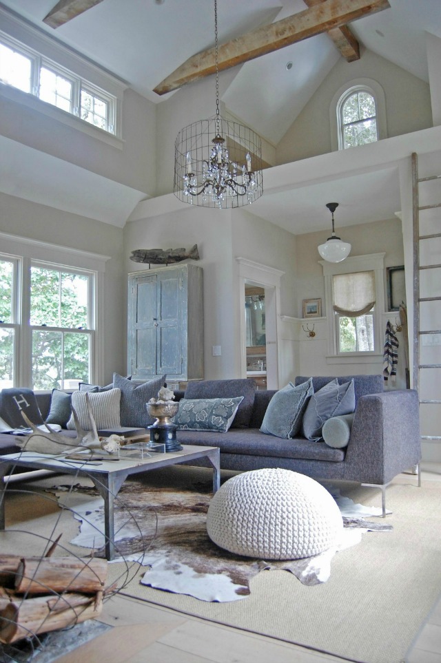 Modern and rustic living room - love the wood beams and warm cowhide kellyelko.com