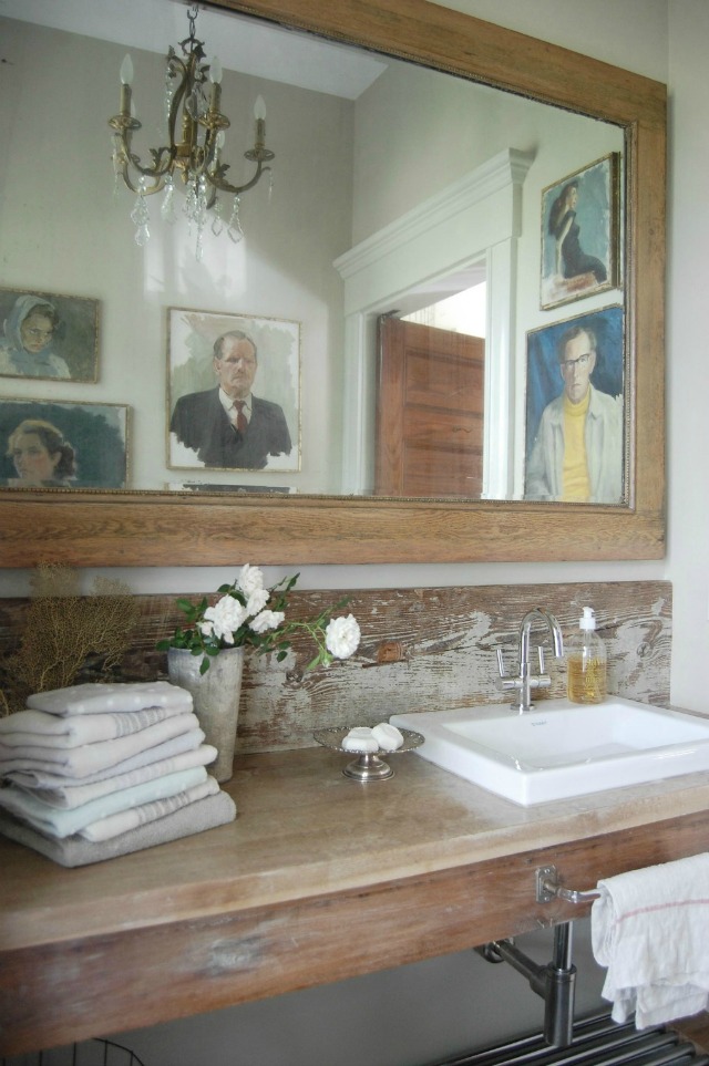 Rustic wood bathroom counter with a fun portrait gallery wall kellyelko.com