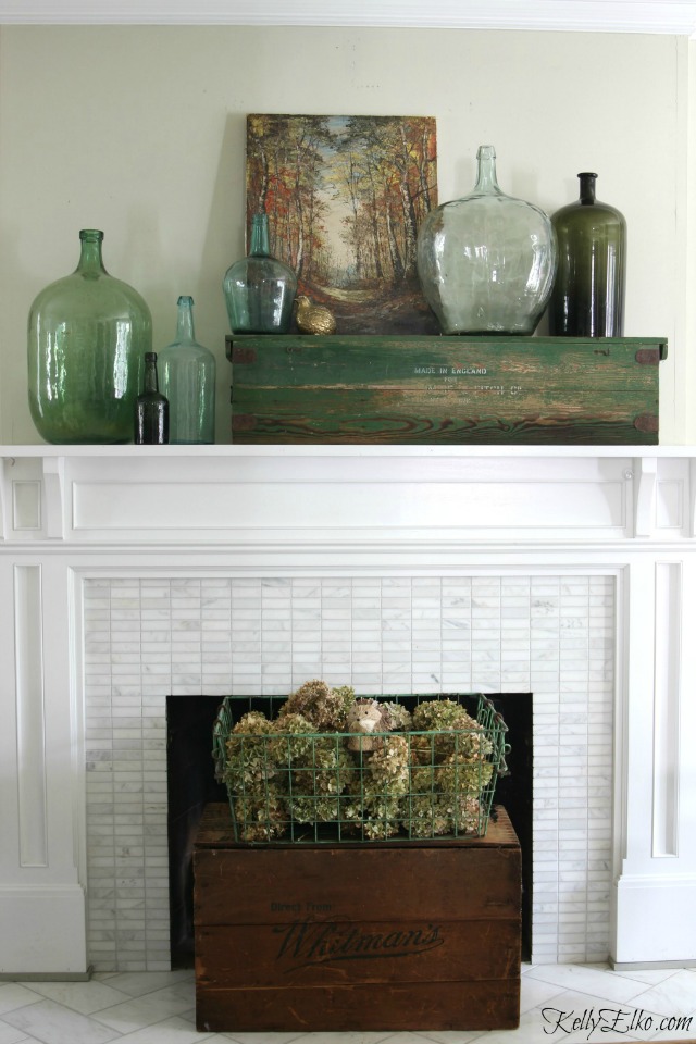 Fall mantel - love the collection of demijohns and the vintage wood box as a fireplace screen kellyelko.com