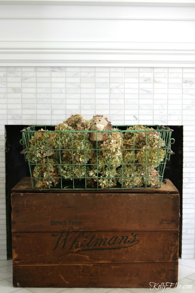Cover up that black hole of a fireplace with vintage crates kellyelko.com