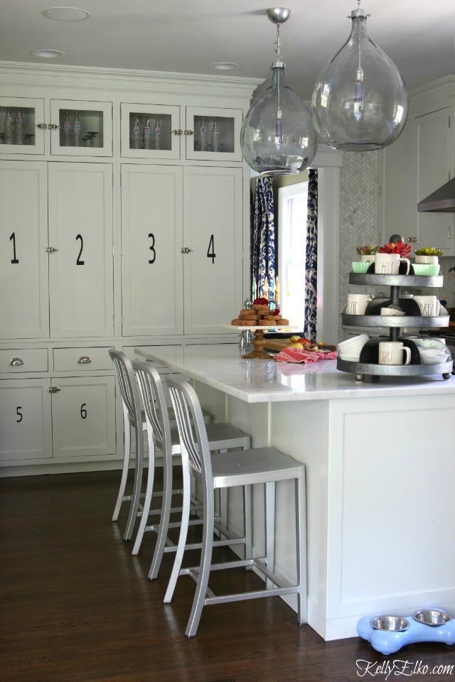 Love this gorgeous white kitchen and the demijohn lights kellyelko.com