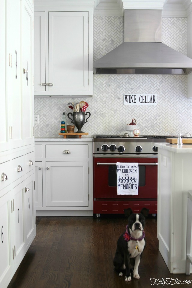 Gorgeous herringbone marble backsplash and red stove kellyelko.com