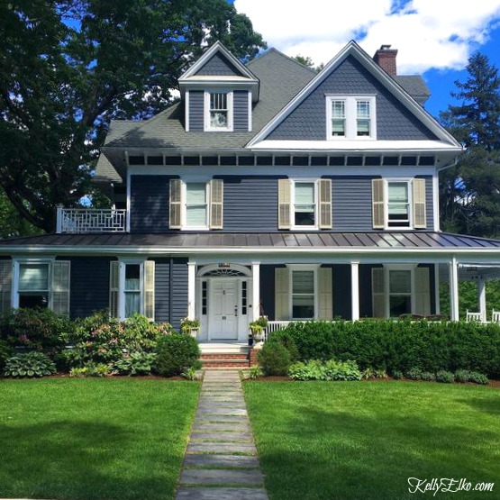 https://www.kellyelko.com/wp-content/uploads/2018/05/old-blue-house-metal-roof-porch-curb-appeal.jpg