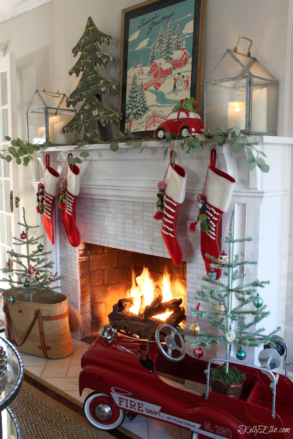 https://www.kellyelko.com/wp-content/uploads/2019/11/vintage-christmas-mantel-pedal-car-feather-trees-shiny-brites-lanterns.jpg